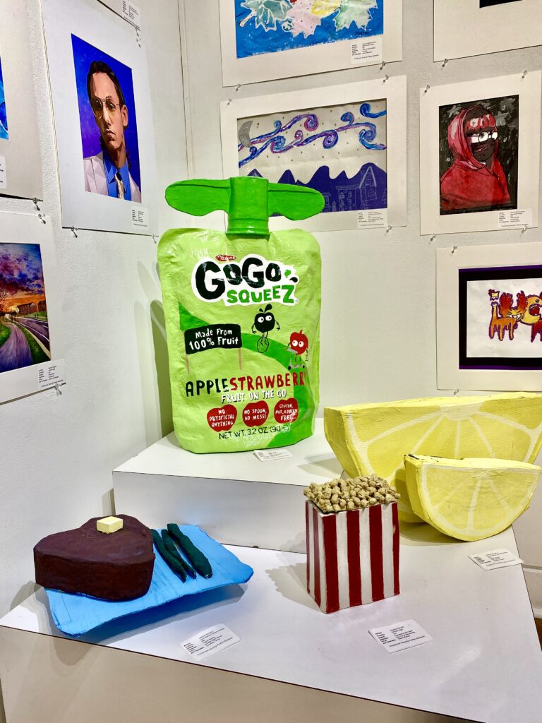 paper mache items of popcorn, lemon slices, applesauce pouch, etc.
